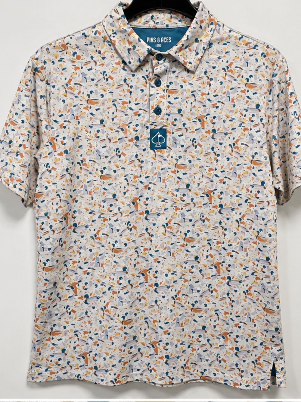 Pins & Aces Men’s Short-Sleeve Polo in White with Blue & Orange Speckle
